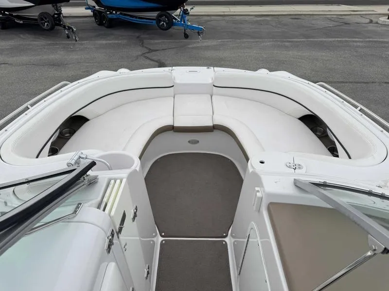 Slide: The Image of 2007 Four Winns 224 Funship boat interior with white seating and gray flooring. - 13