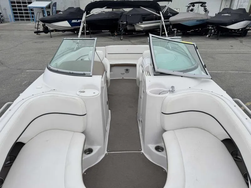 Slide: The Image of 2007 Four Winns 224 Funship boat interior with white seating and open deck layout. - 14