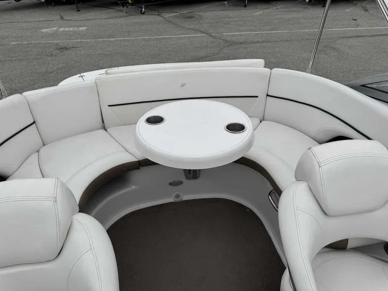 Slide: The Image of 2007 Four Winns 224 Funship boat interior with white seating and round table. - 16