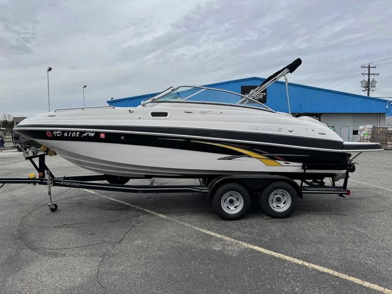 Slide: The Image of 2007 Four Winns 224 Funship boat on trailer in parking lot. - 2