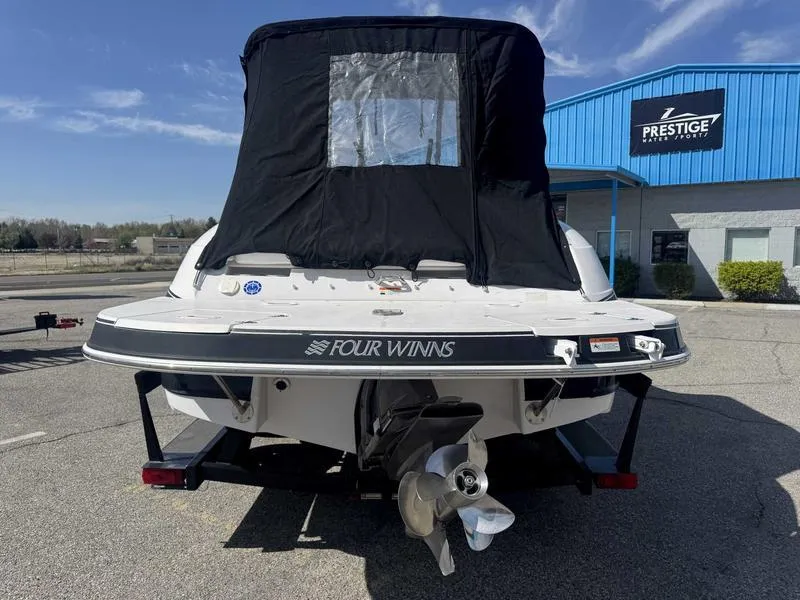 Slide: The Image of 2007 Four Winns 224 Funship boat with black cover, parked at Prestige Auto Sales. - 3