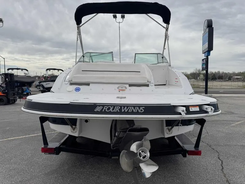Slide: The Image of 2007 Four Winns 224 Funship boat, rear view, on trailer, overcast sky. - 8