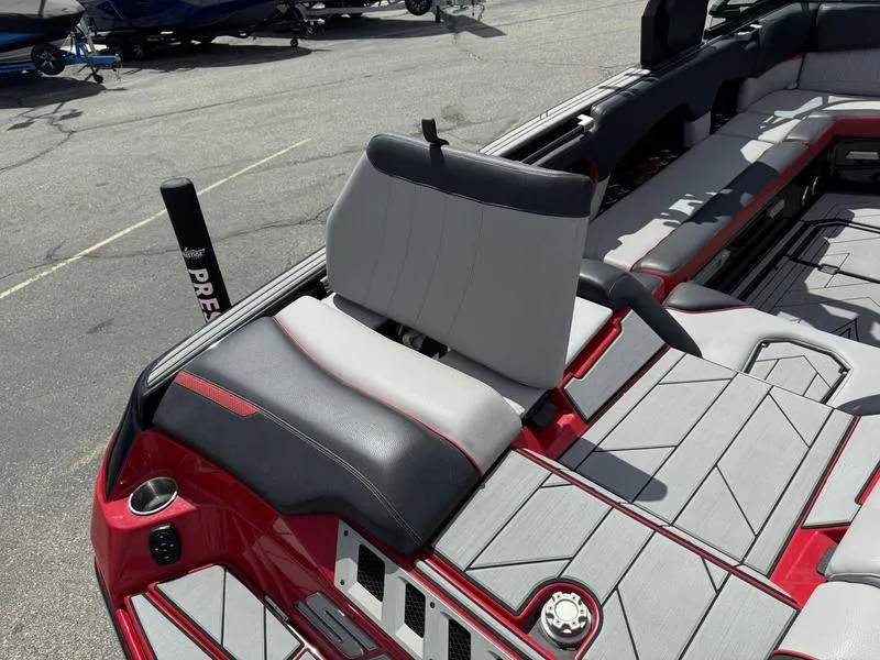 Slide: The Image of 2019 Supra SE550 boat interior with gray and red seating and deck. - 15
