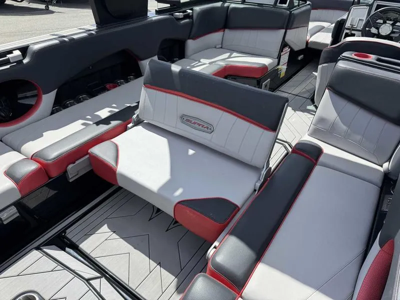 Slide: The Image of 2019 Supra SE550 boat interior with gray, white, and red seating, showcasing luxury and comfort. - 16