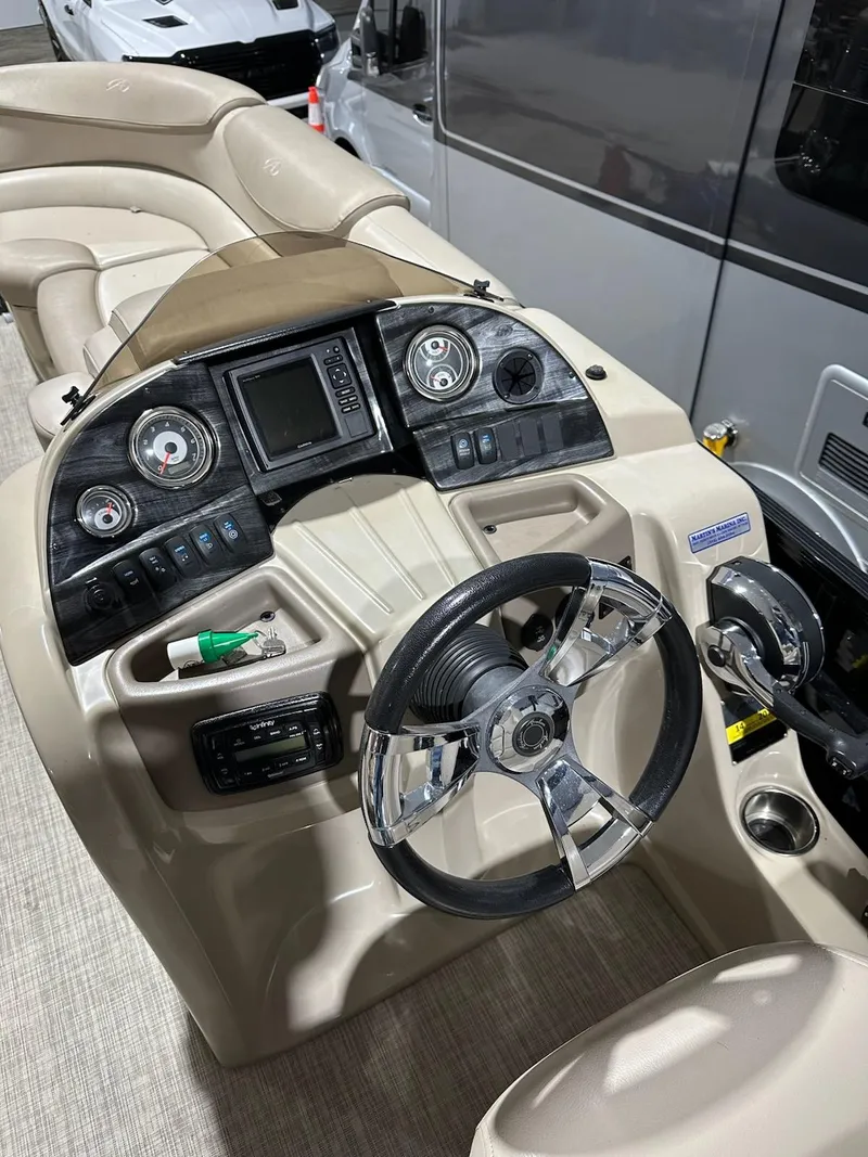 Slide: The Image of 2017 Avalon 2585 RF boat dashboard with steering wheel and control panel. - 3