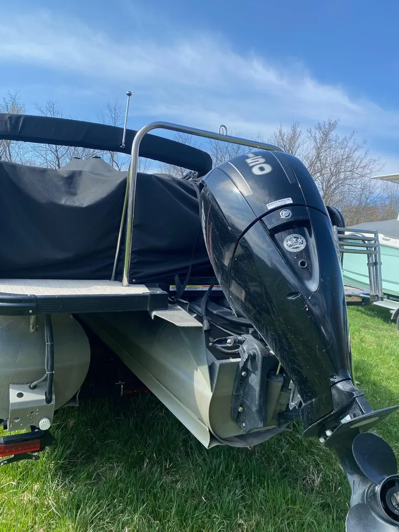 Slide: The Image of 2017 Avalon 2585 RF boat with outboard motor on grassy area. - 4