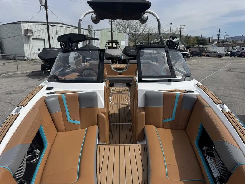 Slide: The Image of 2019 Nautique G25 boat interior with tan and gray seating, open deck, and modern design. - 14