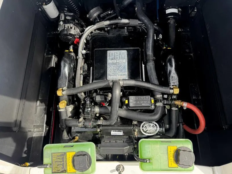 Slide: The Image of 2019 Nautique G25 engine compartment with PCM engine, hoses, and components visible. - 15