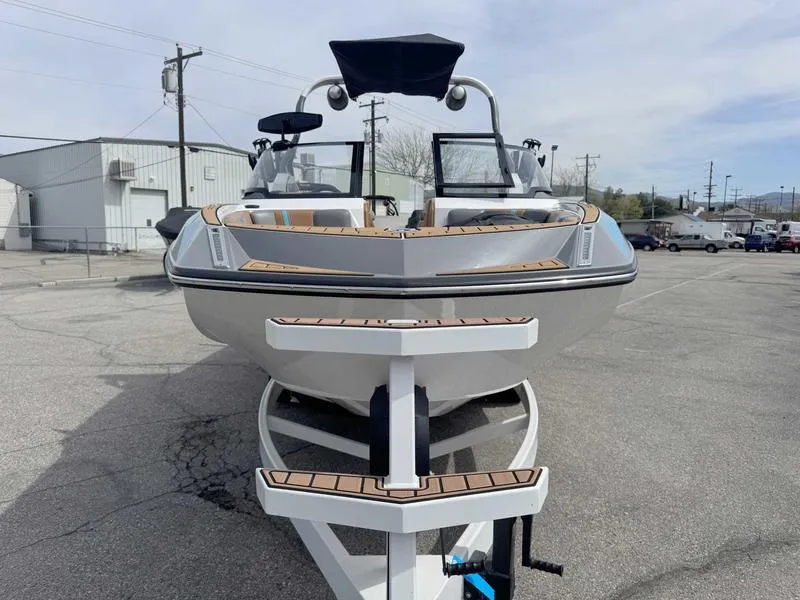 Slide: The Image of 2019 Nautique G25 boat on trailer, viewed from the front in a parking lot. - 4