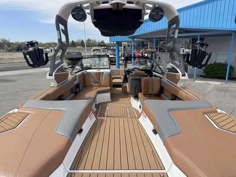 Slide: The Image of 2019 Nautique G25 boat interior with tan seating and modern design features. - 8