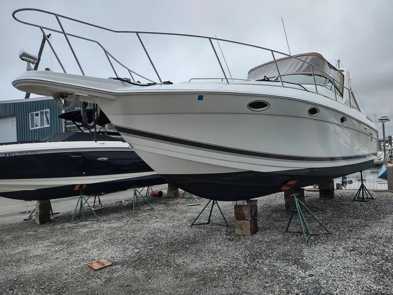 Slide: The Image of 2000 Formula 31PC boat on stands in a marina, side view. - 1