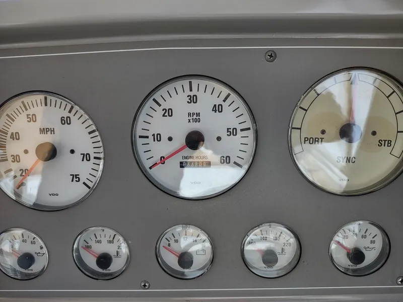 Slide: The Image of Dashboard gauges of a 2000 Formula 31PC boat, displaying speed, RPM, and synchronization. - 10