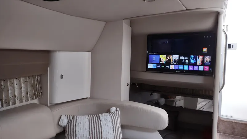 Slide: The Image of Interior of a 2000 Formula 31PC boat with a modern TV setup. - 11