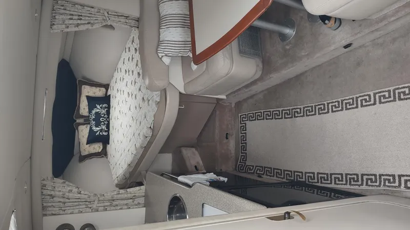 Slide: The Image of Interior of a 2000 Formula 31PC boat with bed, seating, and kitchenette. - 12