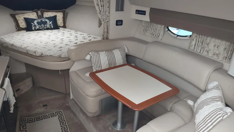 Slide: The Image of Interior of a 2000 Formula 31PC boat with cozy seating and a bed. - 13