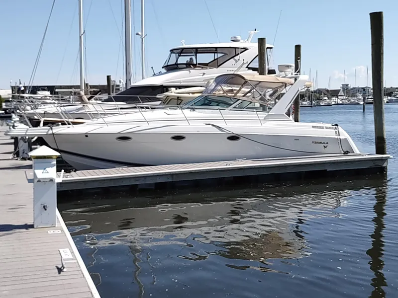 Slide: The Image of 2000 Formula 31PC yacht docked at marina, calm water, clear sky. - 3