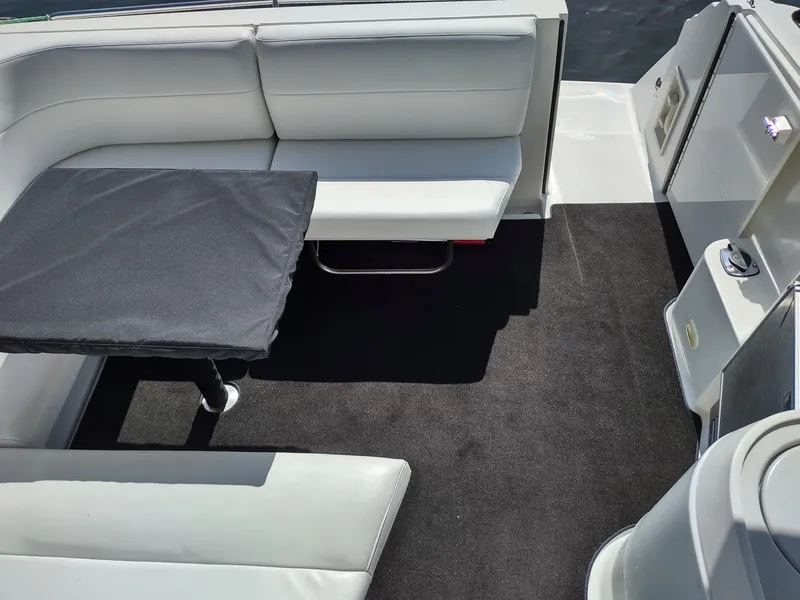 Slide: The Image of 2000 Formula 31PC boat interior with white seating and black table. - 6
