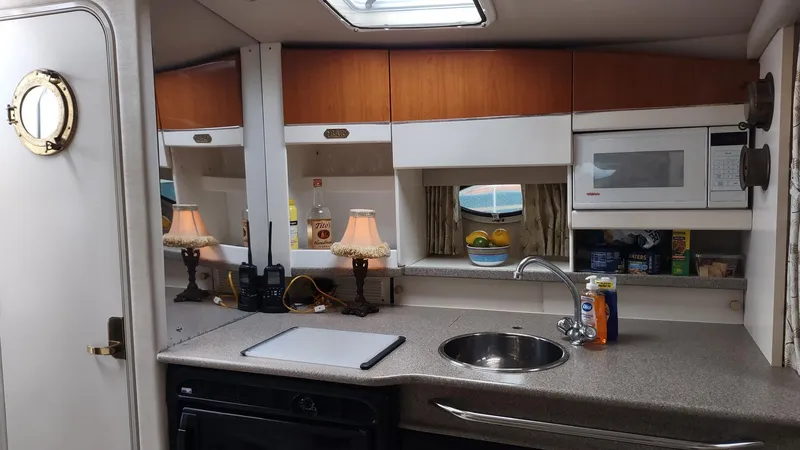 Slide: The Image of Interior of a 2000 Formula 31PC boat kitchen with sink, microwave, and countertop. - 8