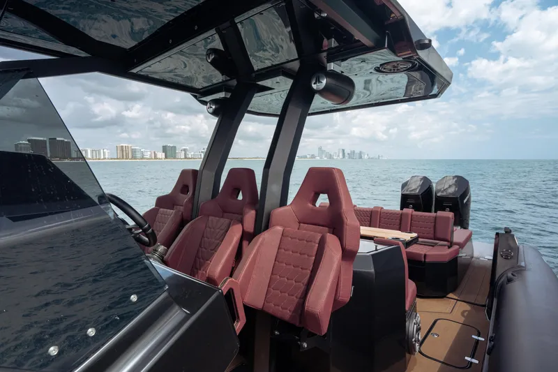 Slide: The Image of Luxury Skipper-BSK 42NC boat interior with red seats, ocean view, 2023 model. - 11
