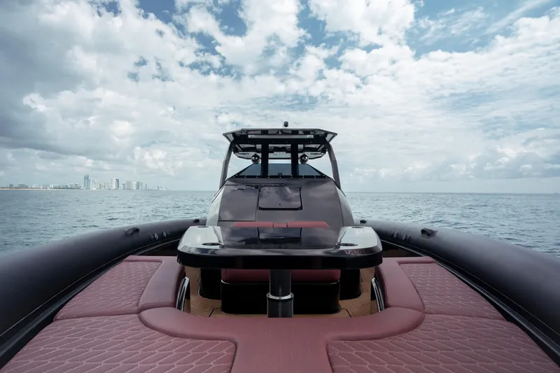 Slide: The Image of 2023 Skipper-BSK 42NC luxury boat on open sea with city skyline. - 12