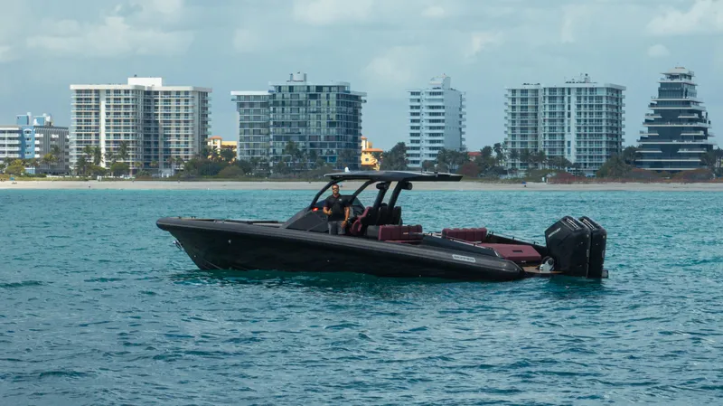 Slide: The Image of 2023 Skipper-BSK 42NC boat on water with city skyline in background. - 8