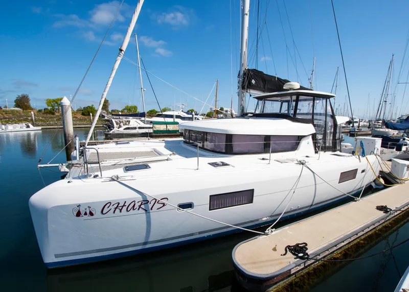 Slide: The Image of 2017 Lagoon 42 catamaran docked in marina under clear blue sky. - 10