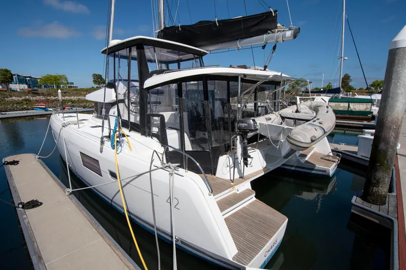 Slide: The Image of 2017 Lagoon 42 catamaran docked at marina, featuring sleek design and modern amenities. - 13