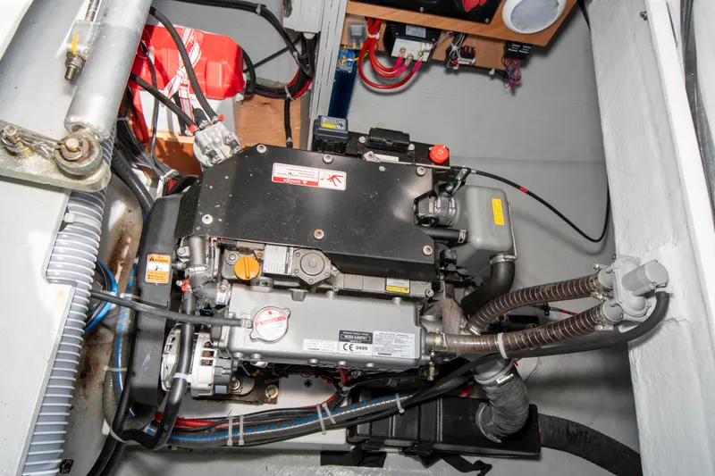Slide: The Image of Engine compartment of a 2017 Lagoon 42 catamaran, showcasing mechanical components and wiring. - 27