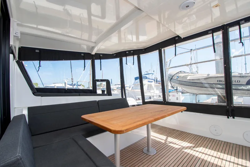 Slide: The Image of Interior of 2017 Lagoon 42 catamaran with seating and wooden table, docked at marina. - 29