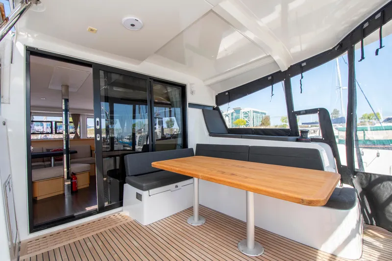 Slide: The Image of 2017 Lagoon 42 yacht interior with wooden table and cushioned seating. - 30