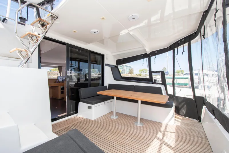 Slide: The Image of 2017 Lagoon 42 yacht interior with seating area and wooden table. - 31