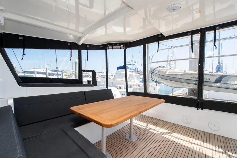 Slide: The Image of Interior of 2017 Lagoon 42 catamaran with seating and table, docked at marina. - 32
