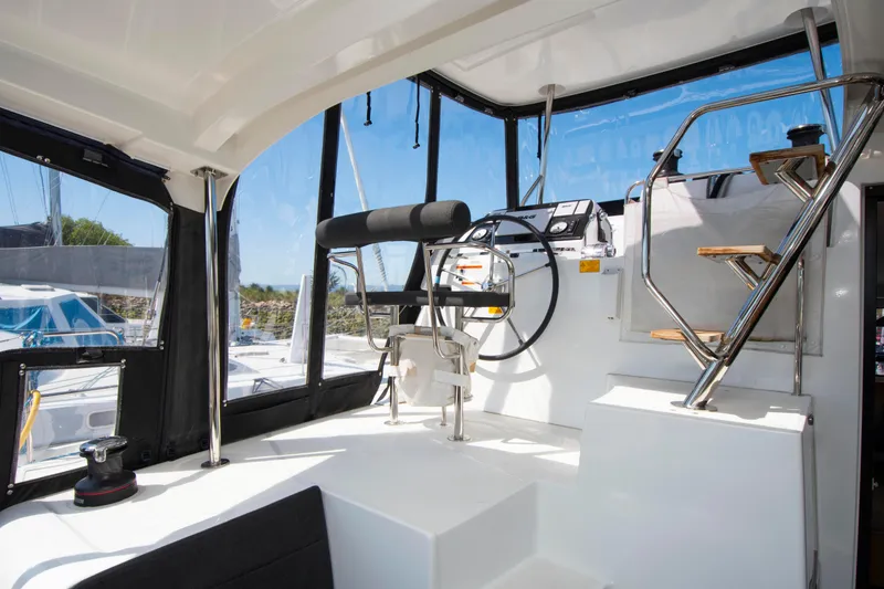 Slide: The Image of Interior view of 2017 Lagoon 42 catamaran helm station with modern steering wheel. - 33