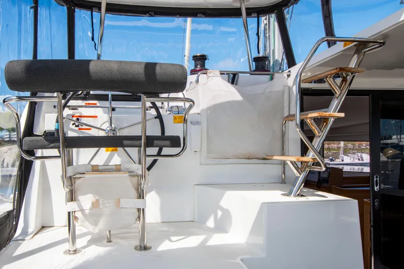 Slide: The Image of Helm station of 2017 Lagoon 42 catamaran with steering wheel and seating. - 34