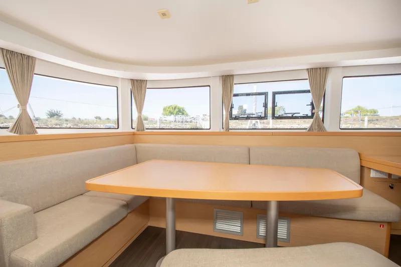 Slide: The Image of Interior of 2017 Lagoon 42 catamaran with spacious seating and large windows. - 42