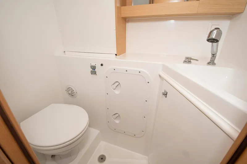 Slide: The Image of Compact bathroom in a 2017 Lagoon 42 yacht, featuring a toilet and sink. - 46
