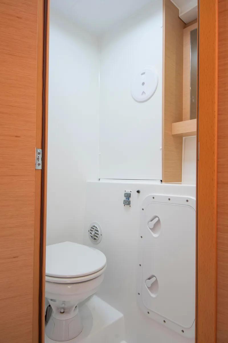 Slide: The Image of 2017 Lagoon 42 yacht bathroom interior with modern fixtures and wooden accents. - 47