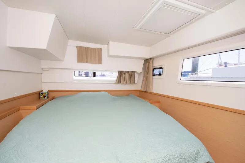 Slide: The Image of Interior cabin of 2017 Lagoon 42 catamaran with a spacious bed and windows. - 49