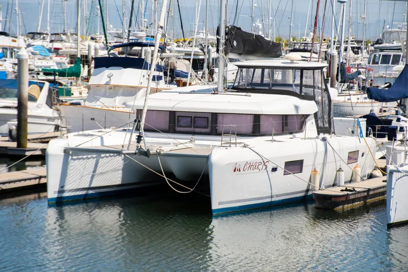Slide: The Image of 2017 Lagoon 42 catamaran docked in a marina, surrounded by other boats. - 6