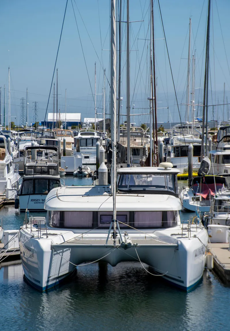 Slide: The Image of 2017 Lagoon 42 catamaran docked in a busy marina. - 8