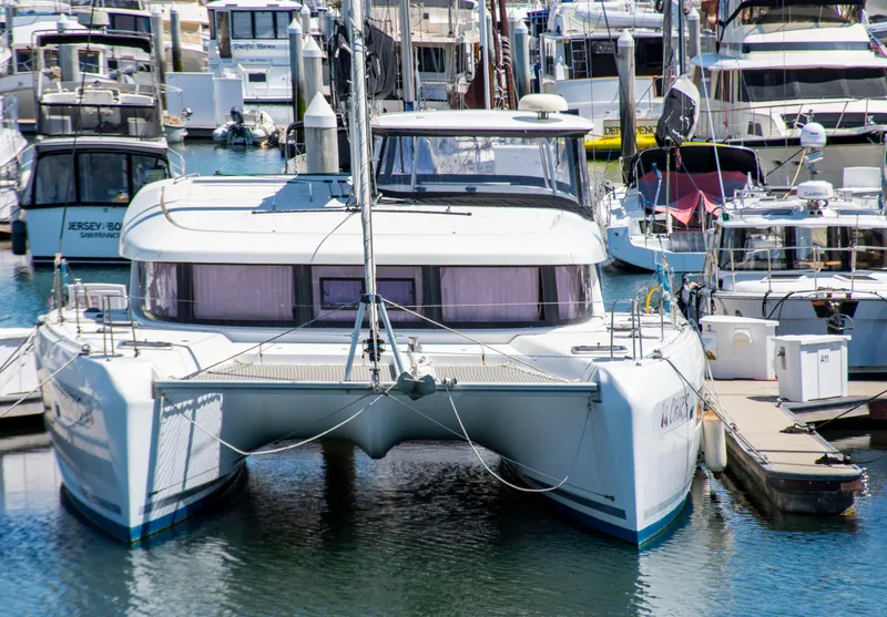 Slide: The Image of 2017 Lagoon 42 catamaran docked in a busy marina. - 9