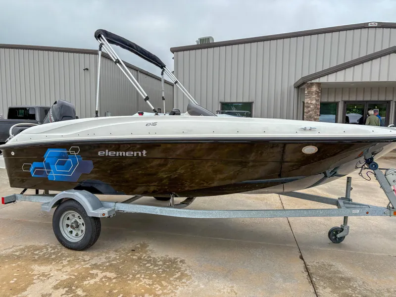 Slide: The Image of 2020 Bayliner Element E16 boat on trailer, parked outside a building. - 1