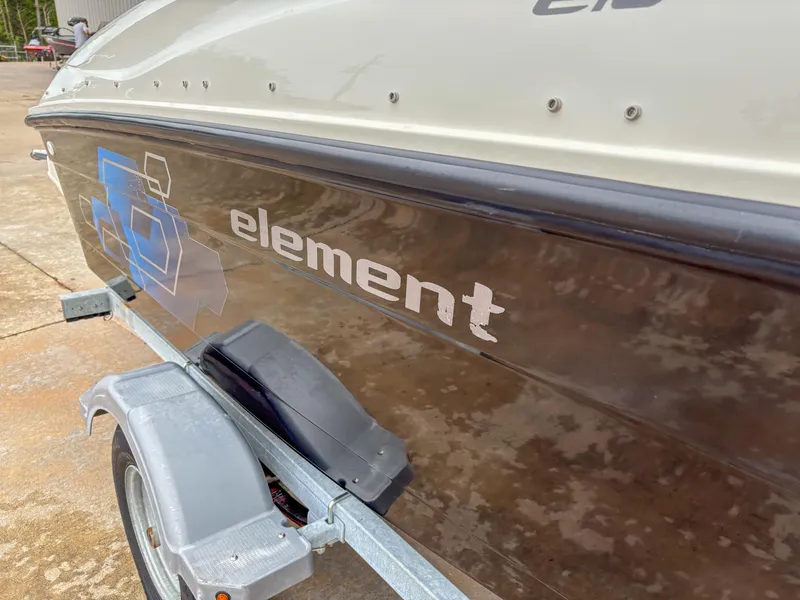 Slide: The Image of 2020 Bayliner Element E16 boat on trailer, side view with logo visible. - 11