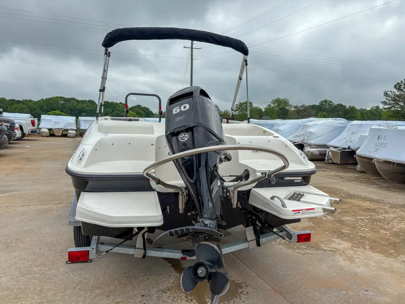 Slide: The Image of 2020 Bayliner Element E16 boat with 60 HP engine, parked outdoors. - 3