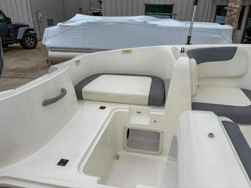 Slide: The Image of 2020 Bayliner Element E16 boat interior with white and gray seating. - 5