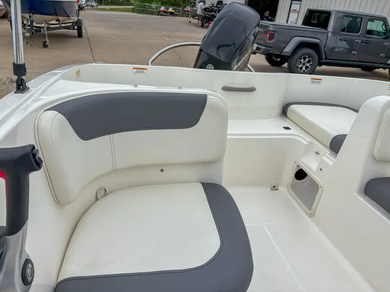 Slide: The Image of 2020 Bayliner Element E16 boat interior with white and gray seating. - 9