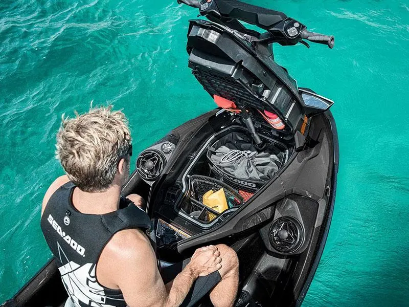 Slide: The Image of 2024 Sea-Doo GTX Limited 300 with iDF Tech Package on turquoise water, storage compartment open. - 4