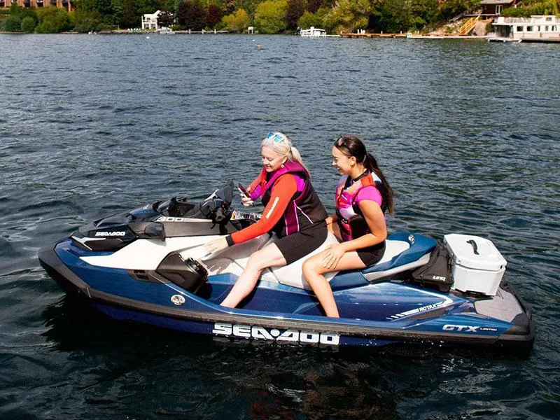 Slide: The Image of Two people riding a 2024 Sea-Doo GTX Limited 300 on a lake. - 8