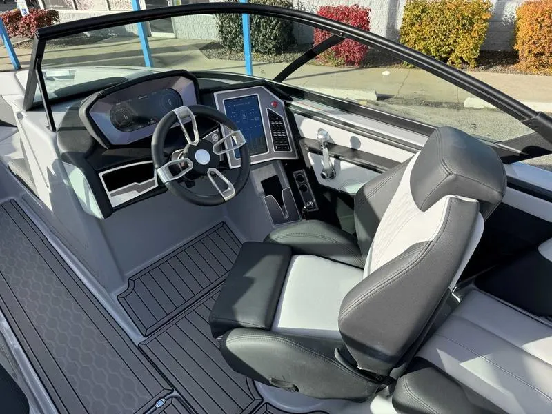 Slide: The Image of 2022 MasterCraft XT23 boat interior with modern dashboard and comfortable seating. - 10