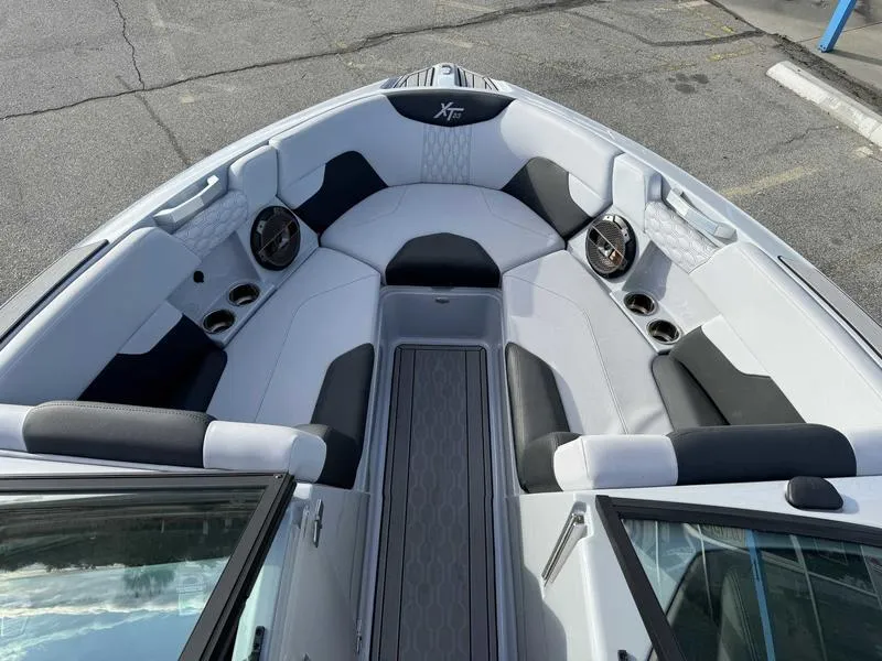 Slide: The Image of 2022 MasterCraft XT23 boat interior with sleek seating and modern design. - 12